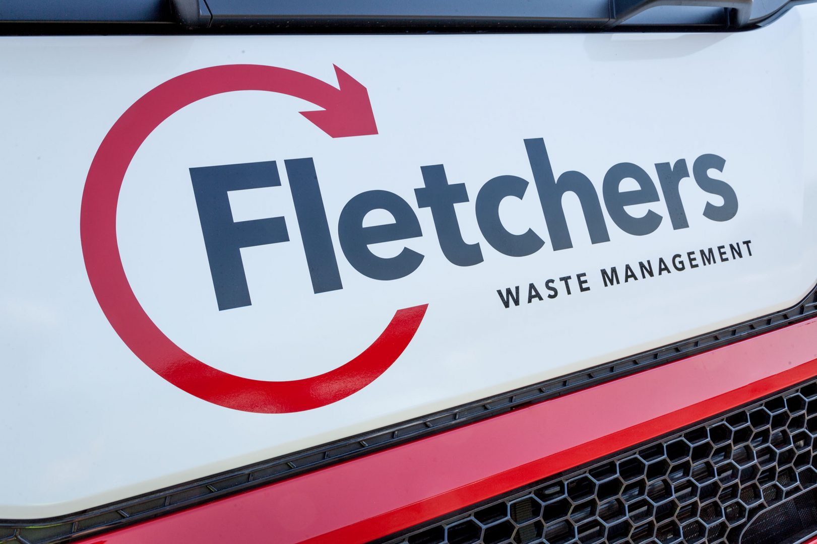 close up of fletchers waste management logo